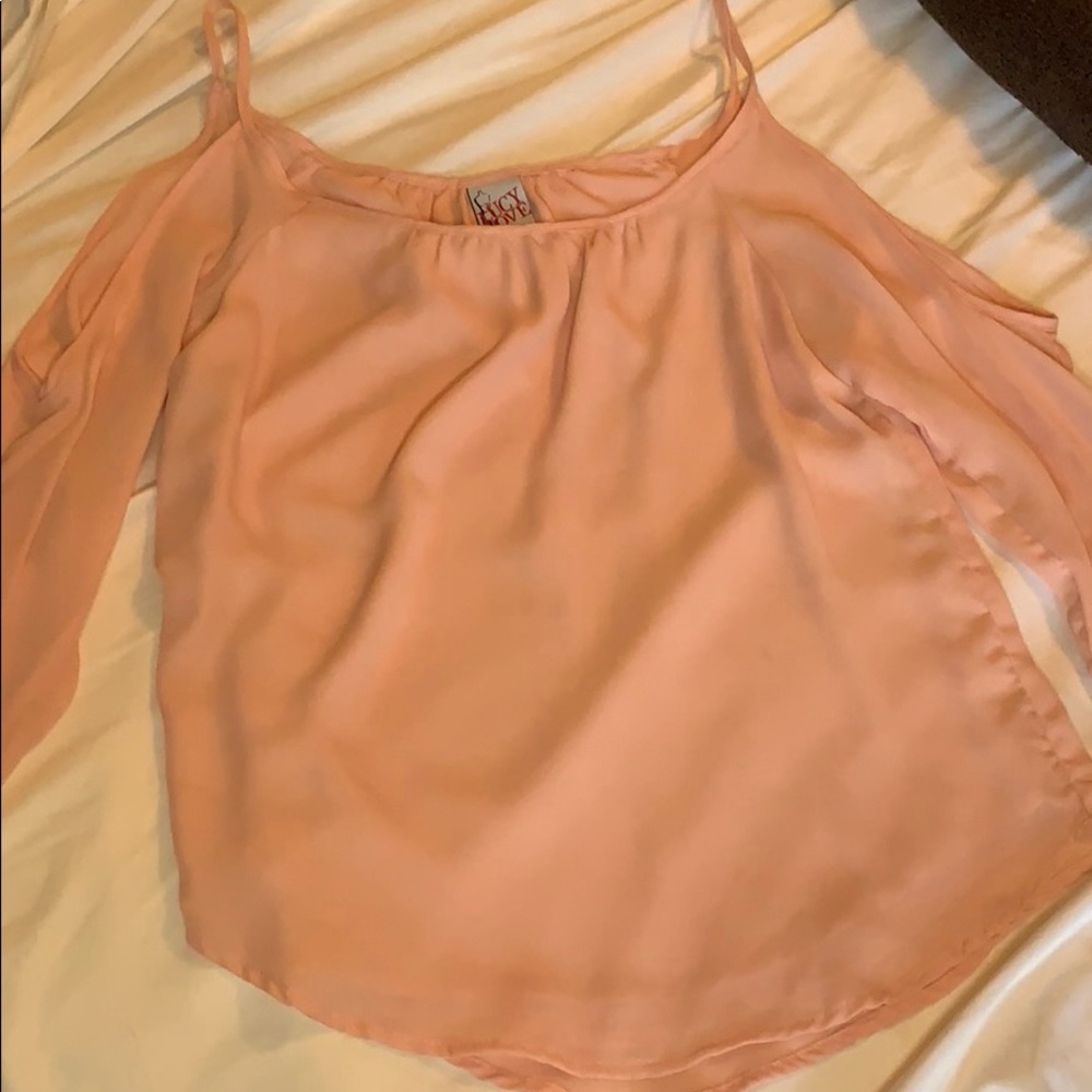 Peach colored cold shoulder top.